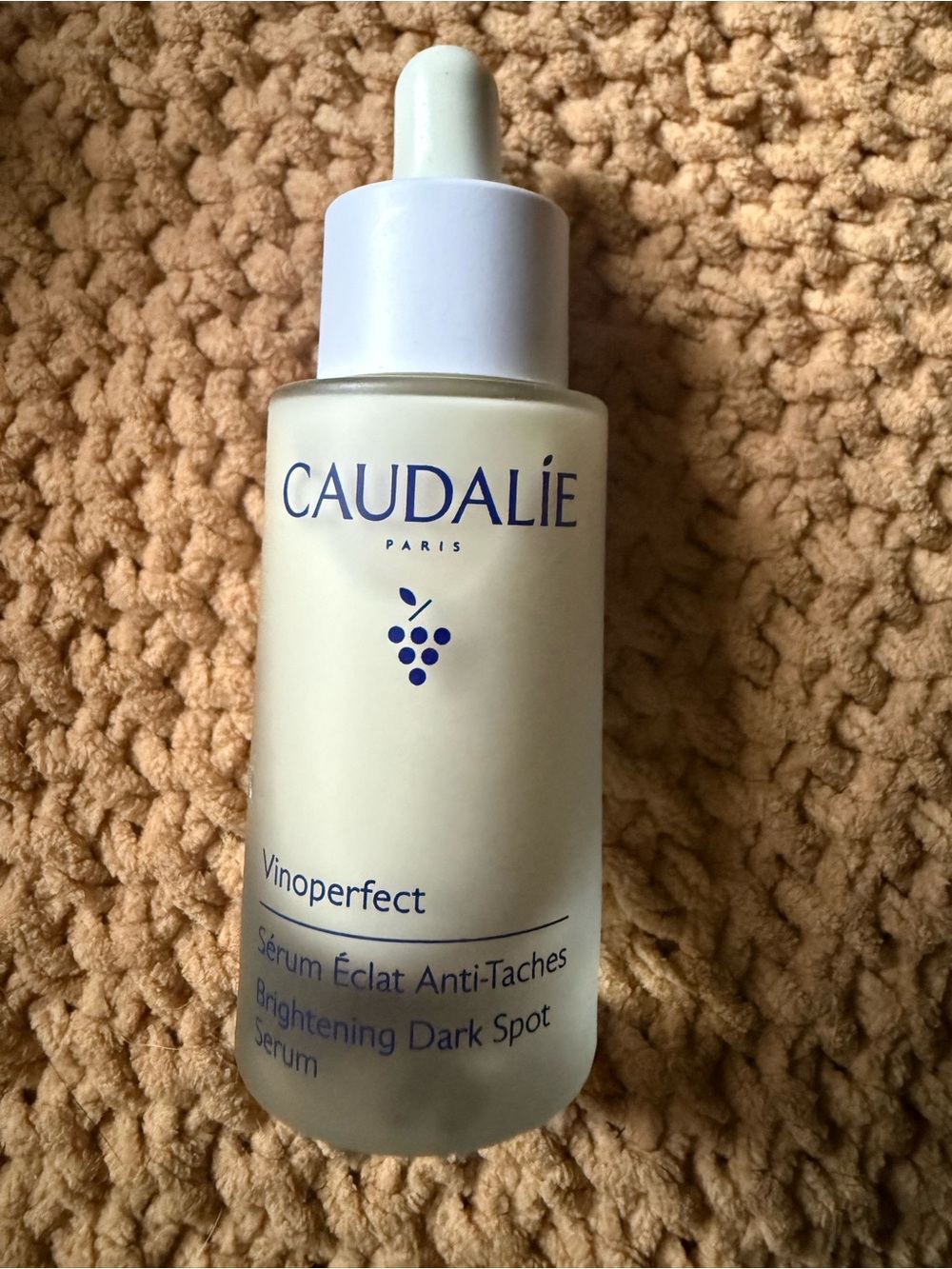 Caudalie Vinoperfect Serum in cream and blue accents